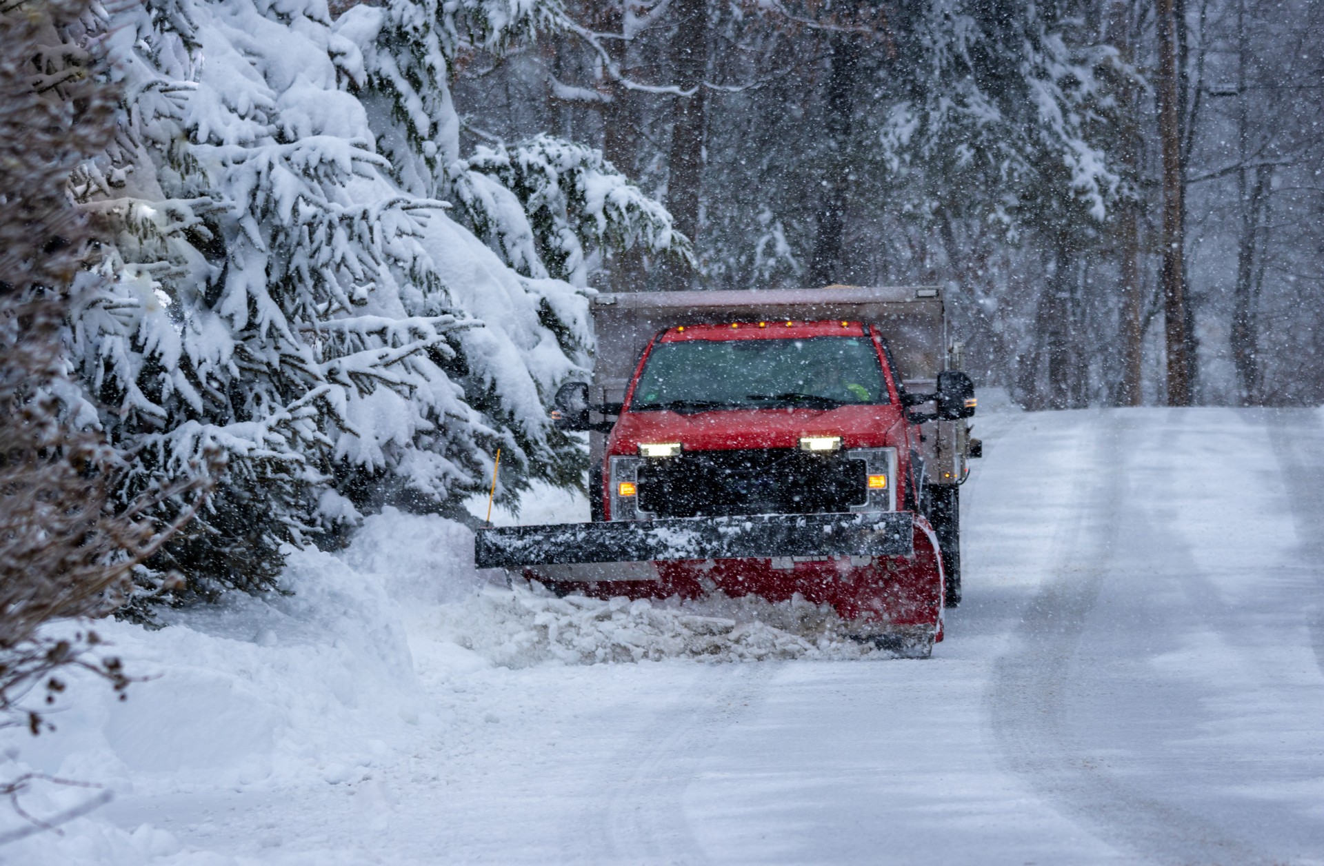 Municipal Snow Plow Truck clearing snow during heavy snowstorm snow falling snow removal